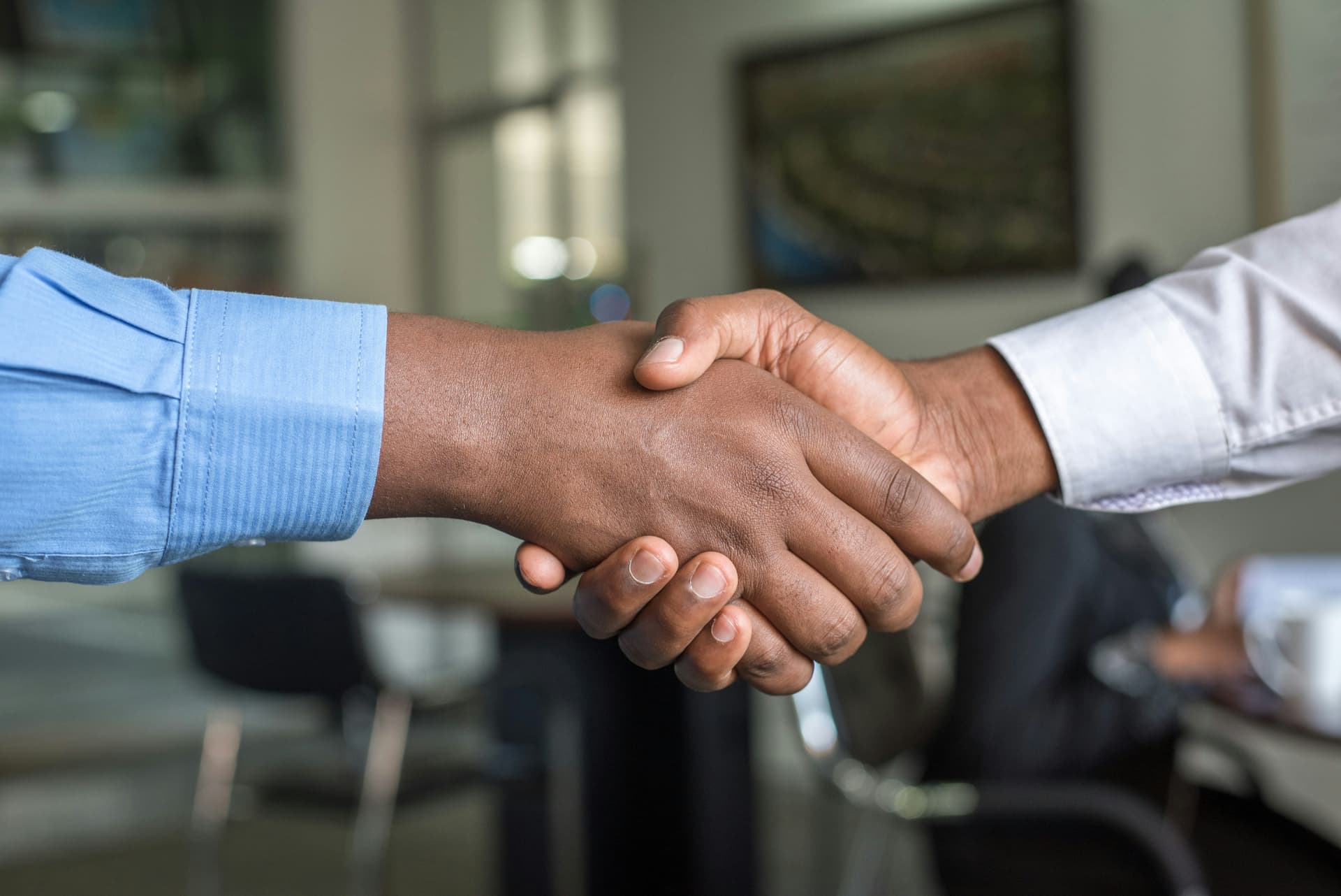Business professionals shaking hands representing our collaborative approach
